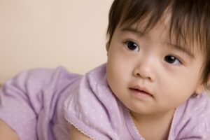 Closeup of baby in purple onesie. 
